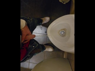 Pissing in a public urinal