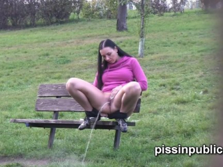 Peeing babes empty their bladders in a park