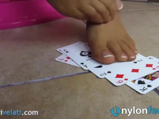 Blonde uses feet in pantyhose to play cards