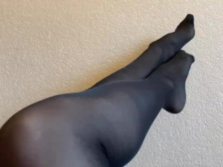 Sexy legs and feet in black nylon pantyhose